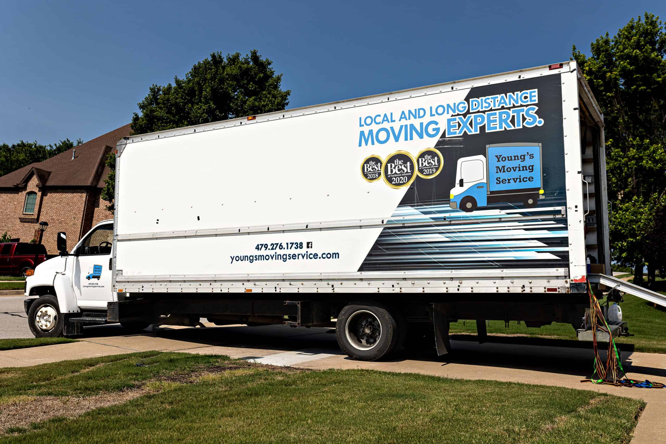 Young's Moving & Storage's moving truck standing in front of a residential property, being moved